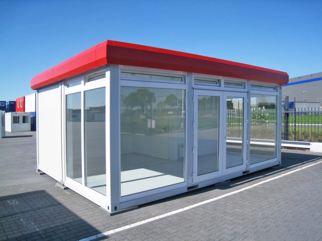 large red and white portable retail cabins in car park with red roof