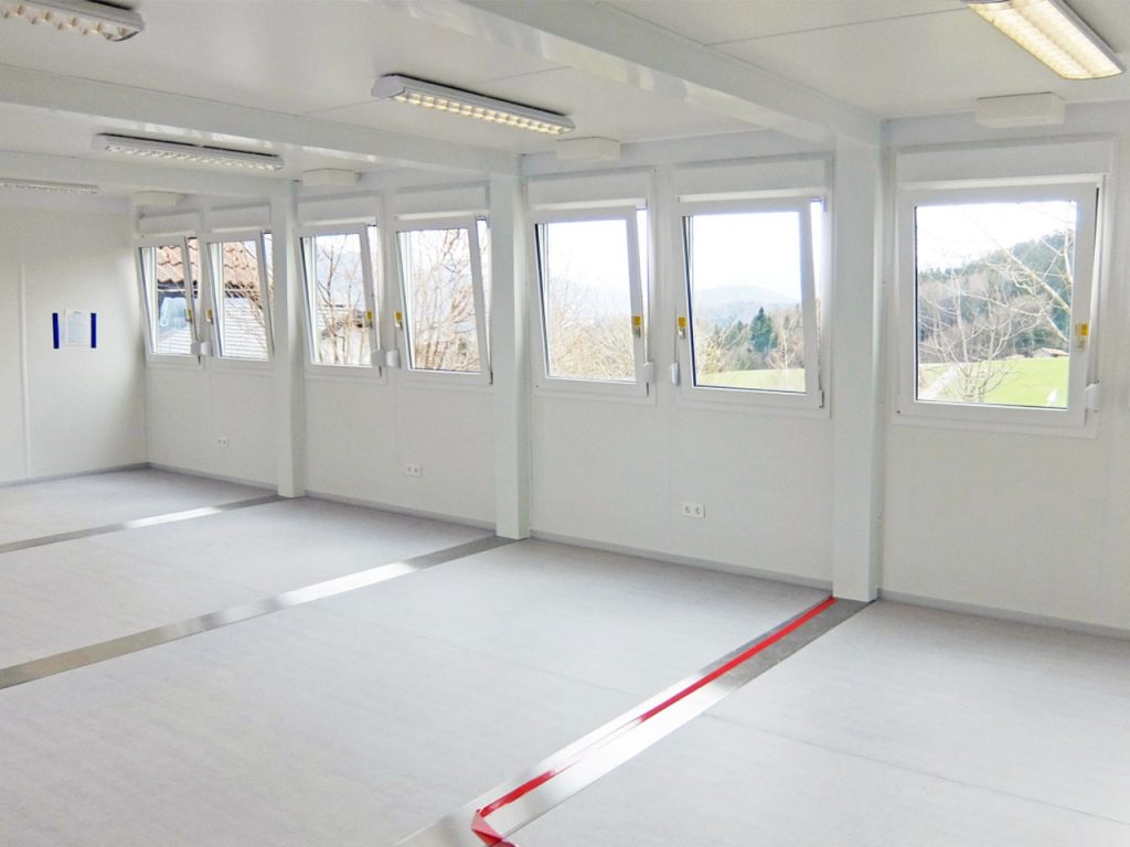 inside a white decorated security cabin with opening windows